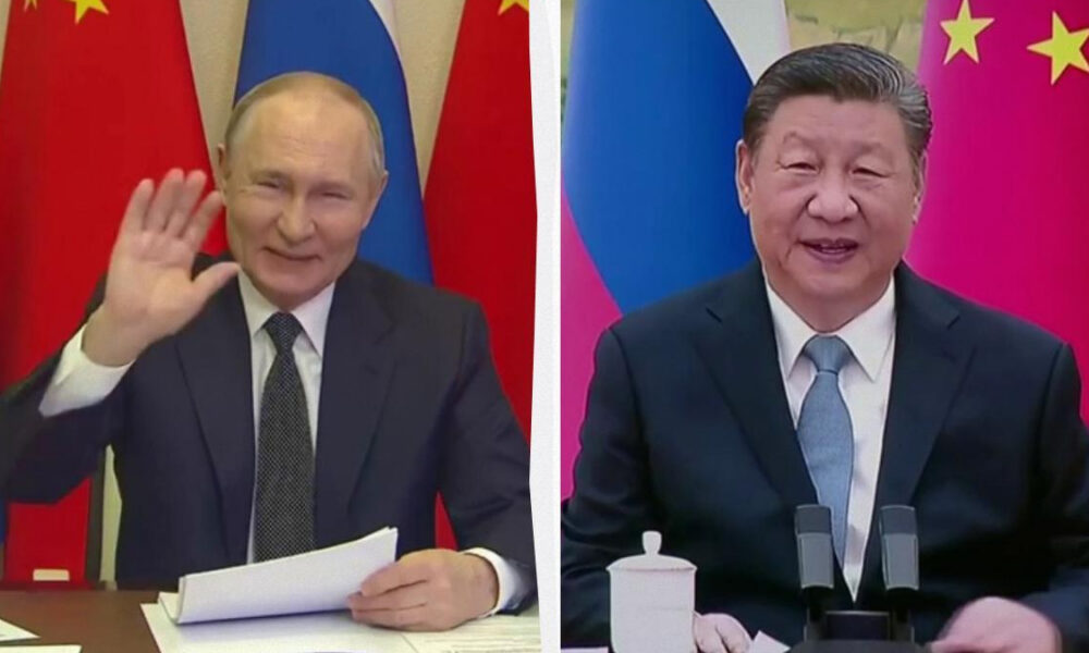Vladimir Putin in a suit waves and holds papers at a desk, with red and blue flags behind. Xi Jinping sits at a table with microphones and a teacup, flags in the background.
