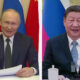 Vladimir Putin in a suit waves and holds papers at a desk, with red and blue flags behind. Xi Jinping sits at a table with microphones and a teacup, flags in the background.