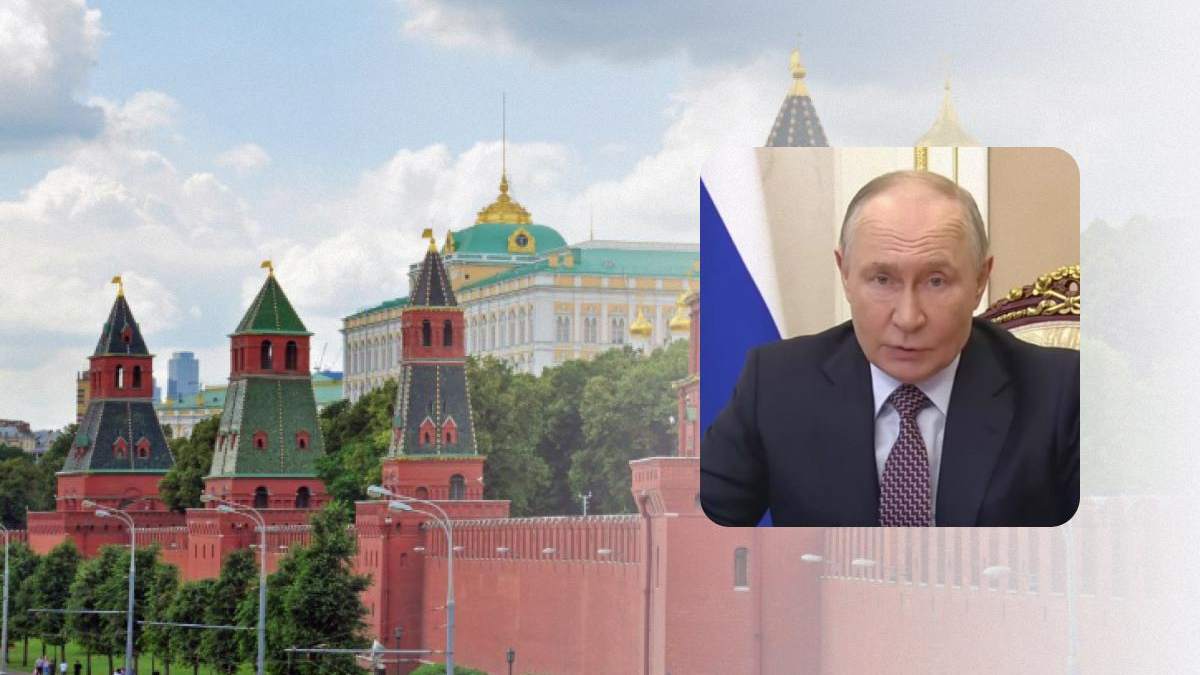 View of the Kremlin towers and red brick wall against a blue sky, with a rounded inset showing a man in a suit speaking in a formal setting.