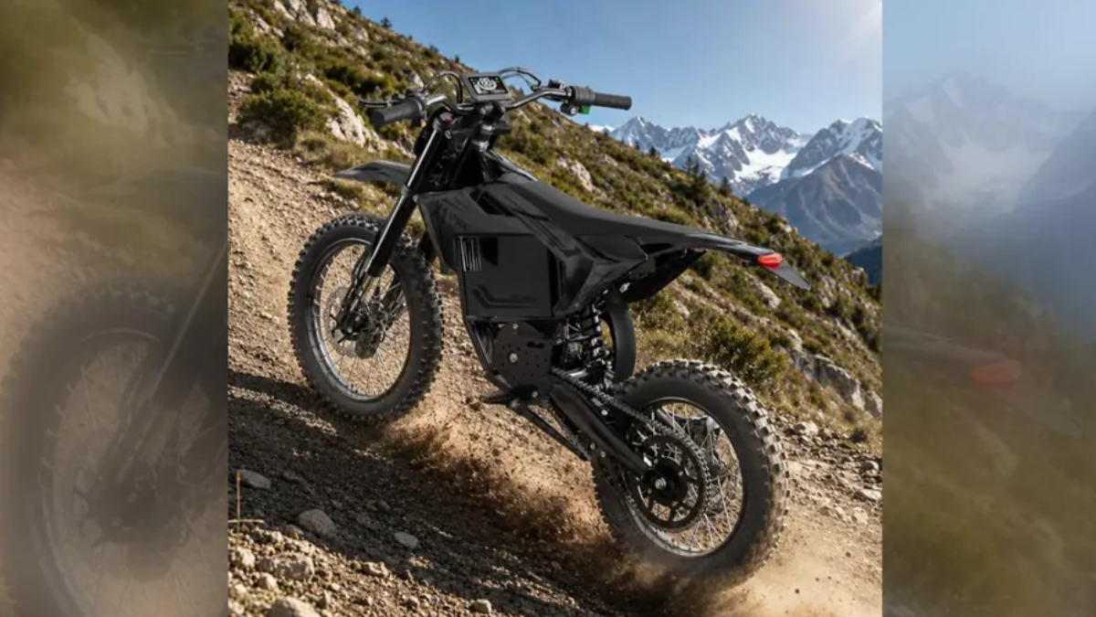 Black electric dirt bike on a rocky mountain trail with snow-capped peaks in the distance.