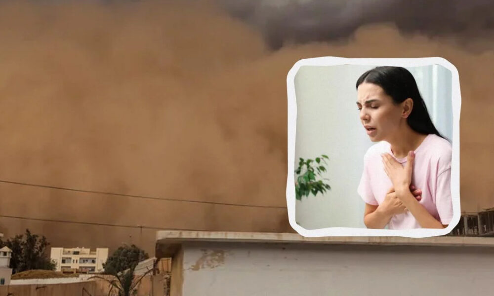 A woman in a pink shirt clutches her chest in distress, shown inside a white-framed cutout over a dusty, stormy city backdrop, suggesting chest pain or a heart emergency.