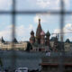 View of Red Square with Saint Basil's Cathedral's colorful domes framed by a metal grid or fence, Moscow, Russia (cityscape scene).