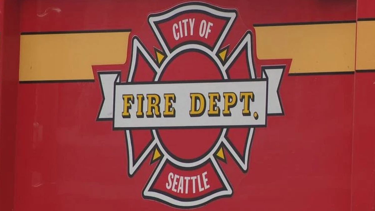 Emblem: City of Fire Dept Seattle badge on a red background with yellow accents and a white banner reading 'FIRE DEPT'.