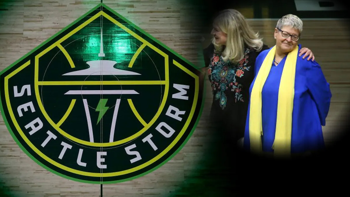Seattle Storm emblem fills the left side as two women walk together on the right, one in a blue gown with a yellow scarf, smiling.