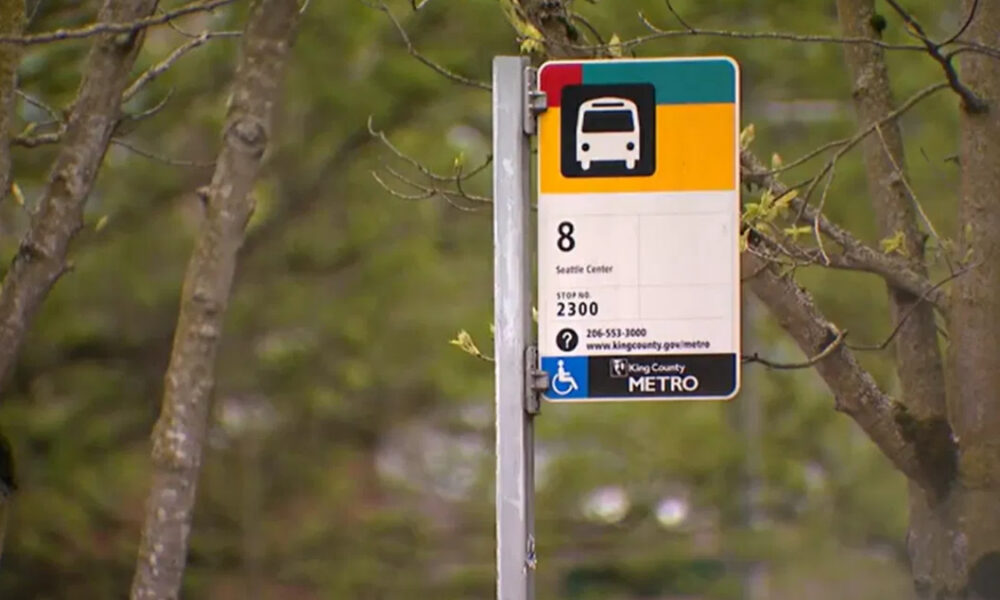 Bus stop sign for Route 8 (Seattle Center) on a metal pole, King County Metro, with wheelchair accessibility symbol nearby