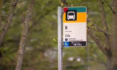 Bus stop sign for Route 8 (Seattle Center) on a metal pole, King County Metro, with wheelchair accessibility symbol nearby