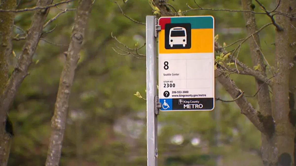 Bus stop sign for Route 8 (Seattle Center) on a metal pole, King County Metro, with wheelchair accessibility symbol nearby