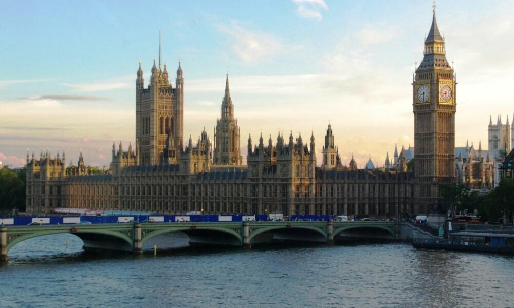 Sunlit view of the Palace of Westminster with Big Ben along the River Thames, seen from Westminster Bridge.