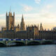 Sunlit view of the Palace of Westminster with Big Ben along the River Thames, seen from Westminster Bridge.