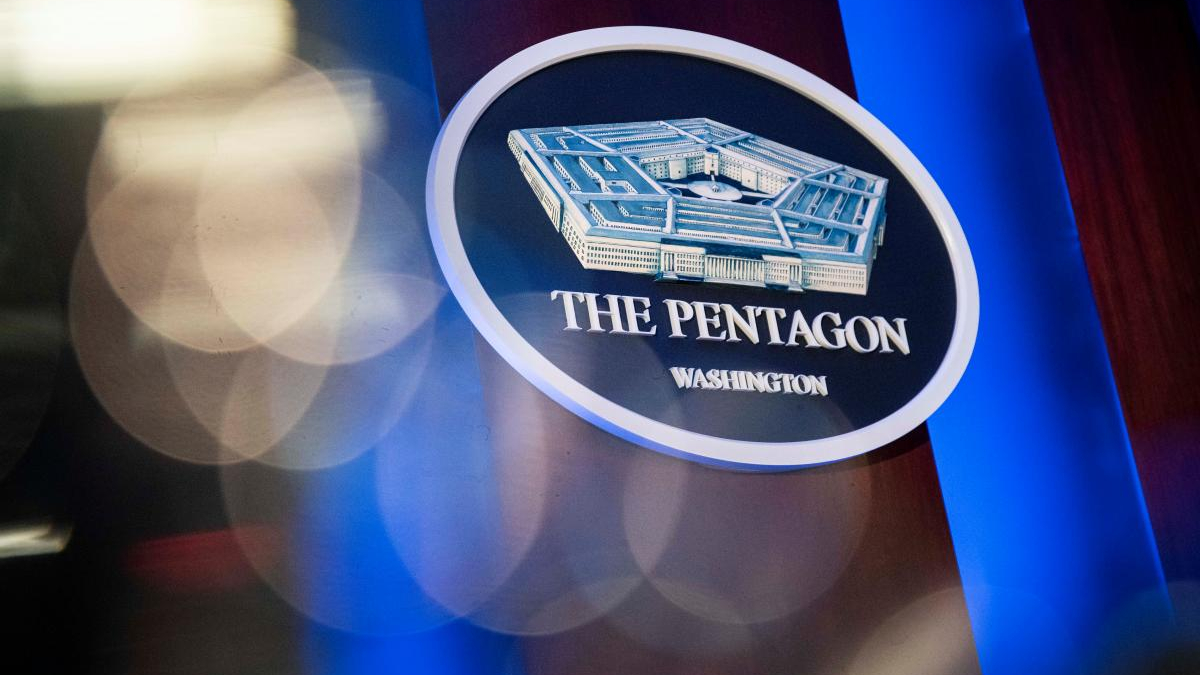 Circular Pentagon emblem with a blue backdrop reading 'The Pentagon, Washington' and a 3D building model in the center.