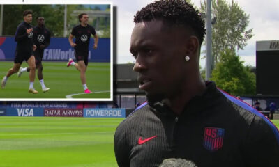 Male US Soccer player being interviewed on a training field, with an inset of three teammates jogging during practice behind him.