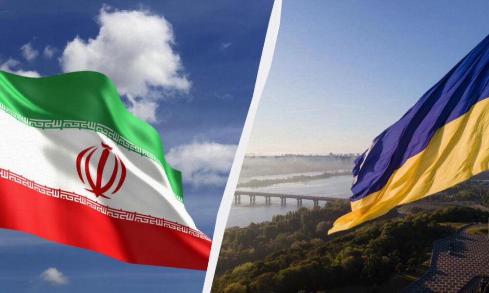Iranian flag waving on the left with green‑white‑red stripes and red emblem, against a blue sky; Ukrainian flag waving on the right over a river and hillside landscape with a bridge, split by a diagonal divider.