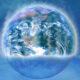 Earth depicted as a translucent bubble resting on a calm blue ocean.