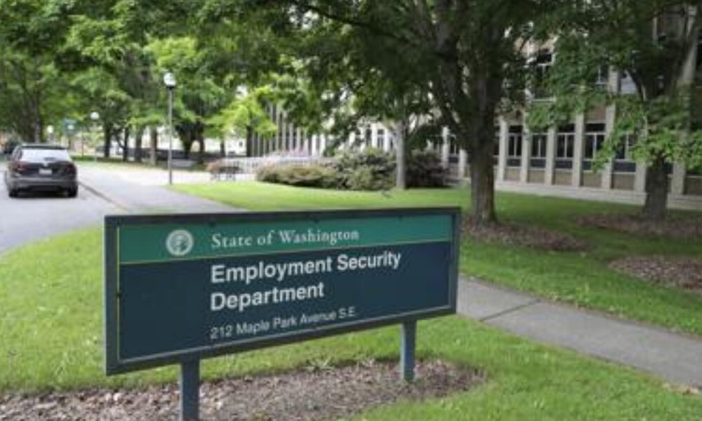 Sign for the State of Washington Employment Security Department on a grassy campus with trees nearby.
