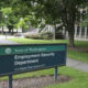 Sign for the State of Washington Employment Security Department on a grassy campus with trees nearby.