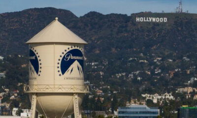 Paramount water tower in foreground with Hollywood sign on hills in the distance