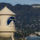 Paramount water tower in foreground with Hollywood sign on hills in the distance