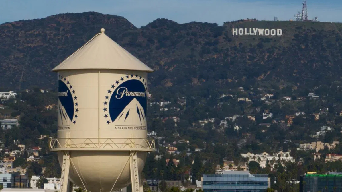 Paramount water tower in foreground with Hollywood sign on hills in the distance