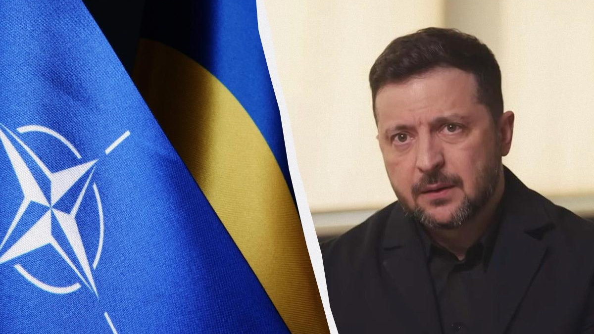 Blue NATO flag on the left and a man in a dark suit speaking indoors on the right, separated by a curved white divider.