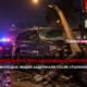 Nighttime crash scene: a damaged SUV with a toppled utility pole leaning on it, police cars flashing in the background and a storefront sign nearby.