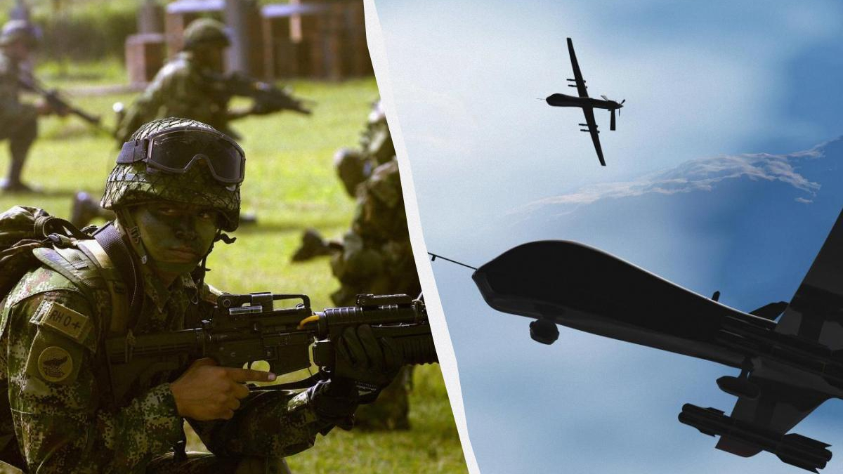 Soldier in camouflage aiming a rifle during training on a grassy field, background soldiers visible on the left.