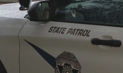 Washington State Patrol vehicle side with 'STATE PATROL' text and official badge emblem on the door