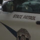 Washington State Patrol vehicle side with 'STATE PATROL' text and official badge emblem on the door