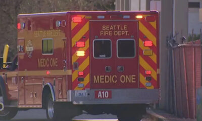 Rear view of a Seattle Fire Department Medic One ambulance with red and yellow chevrons parked on a street