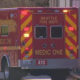 Rear view of a Seattle Fire Department Medic One ambulance with red and yellow chevrons parked on a street