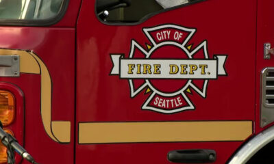 Red fire department vehicle with Seattle City of Fire Dept emblem on the door panel.