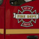 Red fire department vehicle with Seattle City of Fire Dept emblem on the door panel.