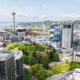 Aerial view of downtown Seattle with the Space Needle in the center, surrounded by glass skyscrapers and a green park in the foreground.