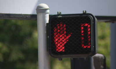 Pedestrian crossing signal showing a red 'don't walk' hand and a 0 timer.
