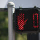 Pedestrian crossing signal showing a red 'don't walk' hand and a 0 timer.