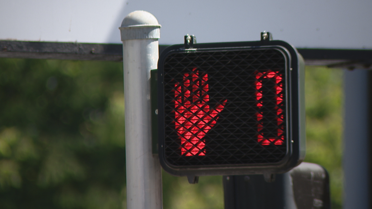 Pedestrian crossing signal showing a red 'don't walk' hand and a 0 timer.