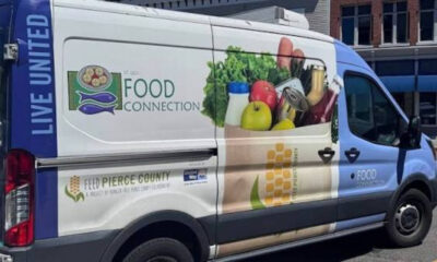Food distribution van with 'Food Connection' branding and groceries graphic on the side, part of a community food program.