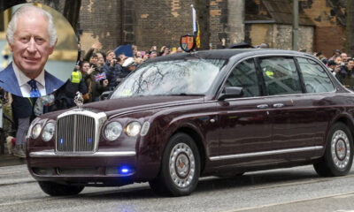 Maroon luxury sedan driving past a crowd of spectators on a city street; circular inset shows a man in a blue suit portrait.