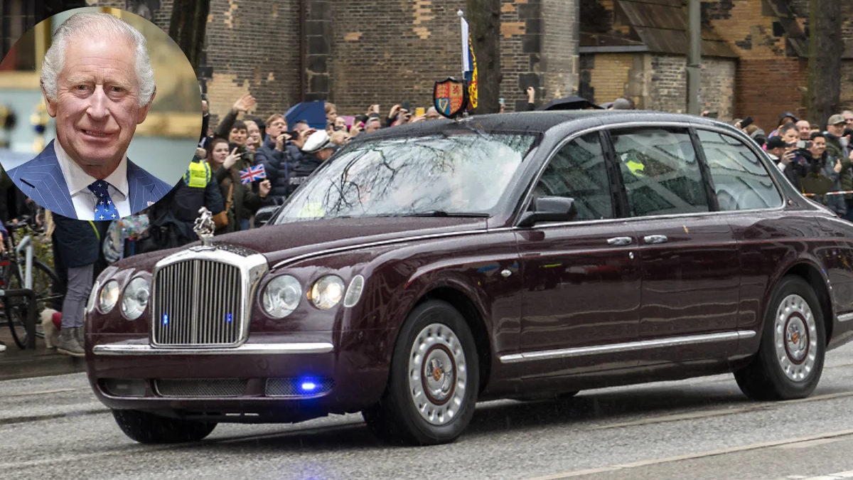 Maroon luxury sedan driving past a crowd of spectators on a city street; circular inset shows a man in a blue suit portrait.