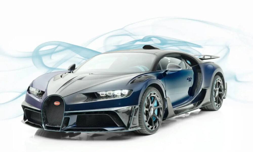 Front three-quarter view of a dark blue Bugatti sports car with butterfly doors open against a white studio backdrop.