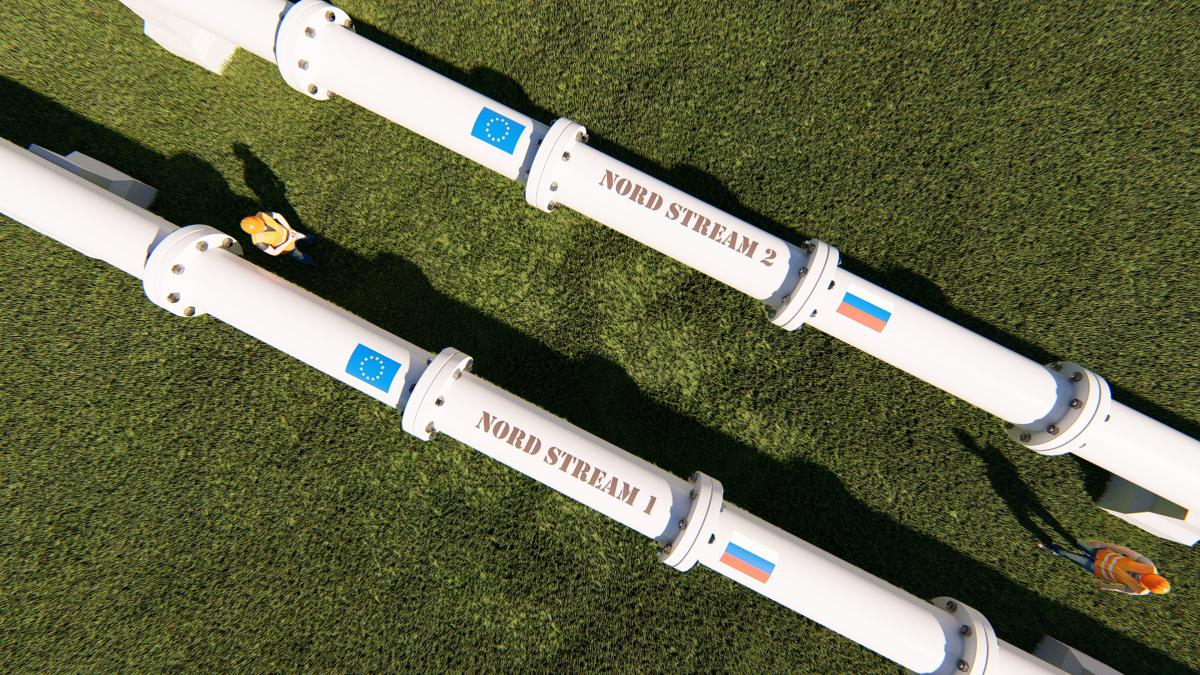 Overhead view of white Nord Stream 1 and Nord Stream 2 gas pipelines lying on green grass, labeled on each segment.