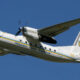 White Ukrainian military aircraft in flight with 'Збройні Сили України' along the fuselage and Ukrainian insignia on the tail.