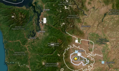 Map showing an earthquake epicenter near Yakima with concentric hazard rings and surrounding cities like Olympia and Kennewick.