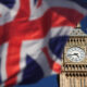 Big Ben clock tower in London with a blurred Union Jack flag in the foreground