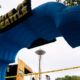 Large blue inflatable arch forms a finish line gate at an outdoor Seattle event, with the Space Needle visible in the background and caution tape across the area.