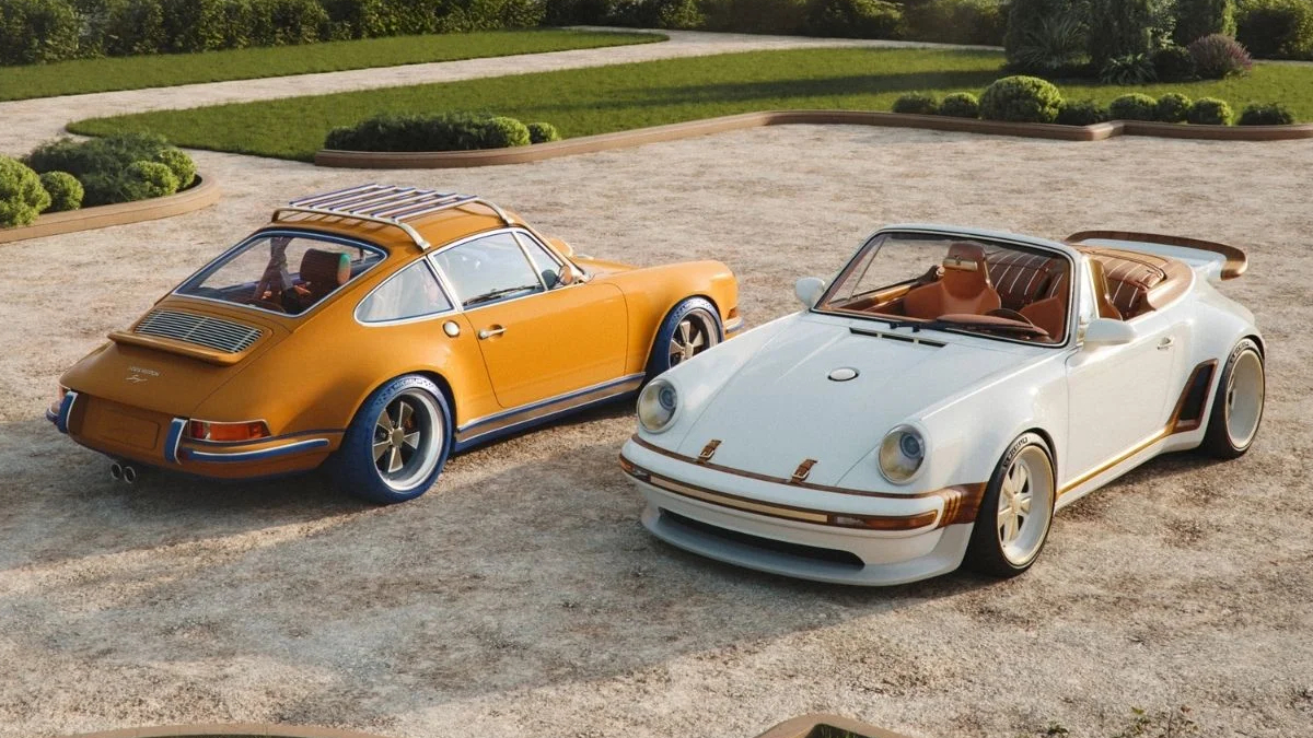 Two vintage Porsche convertibles parked on a gravel driveway with neatly trimmed shrubs in the background.