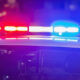 Police car with red and blue emergency lights flashing at night.