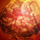 Globally warming theme: Earth with a large thermometer overlay signaling rising temperatures.