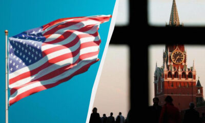 Waving US flag against a blue sky on the left, with Moscow's Kremlin clock tower visible through a dark window on the right (split image).