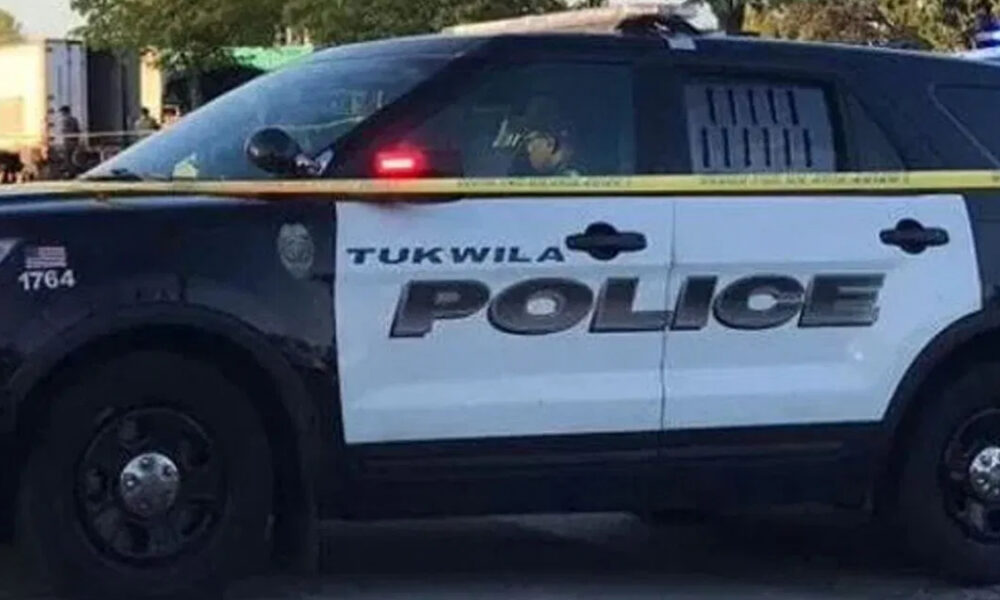 Tukwila Police Department SUV parked with yellow police tape in front, crime scene setting.