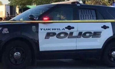 Tukwila Police Department SUV parked with yellow police tape in front, crime scene setting.